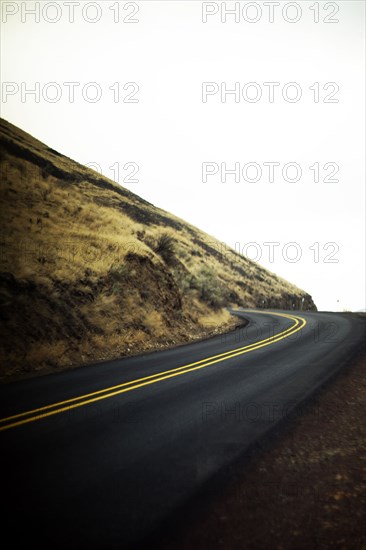 Curved Two-Lane Highway climbing up Hillside,,