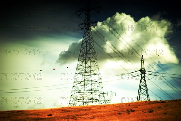 Transmission Towers and Cloudy Sky in Rural Landscape ,,