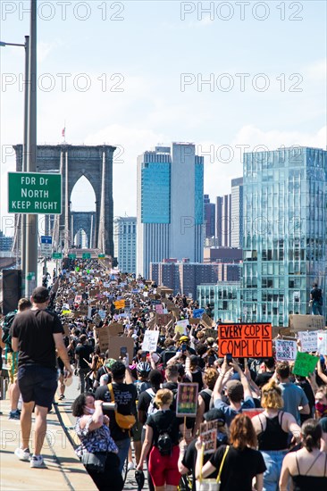 Crowd of Protesters with Signs Marching across Brooklyn Bridge during Juneteenth March, New York City,