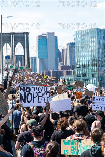 Crowd of Protesters with Signs Marching across Brooklyn Bridge during Juneteenth March, New York City,