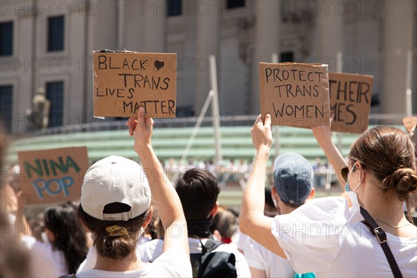 Protesters holding up Black Trans Lives Matter and Protect Trans Women Signs during Protest outside Brooklyn Museum, Brooklyn,