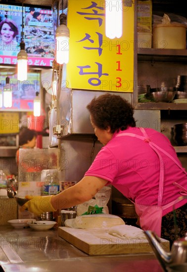 Woman cooking Market, Seoul,