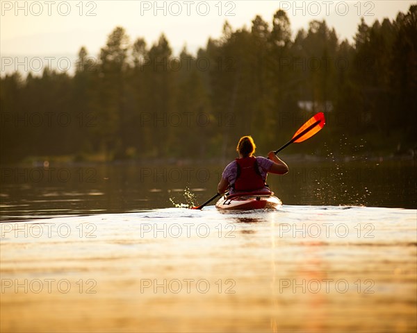 Rear View of Woman Kayaking,,