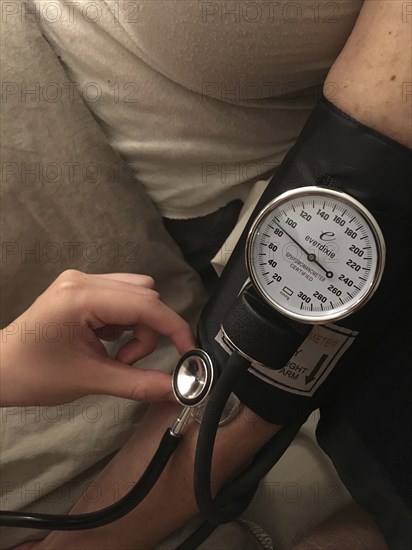 Nurse taking Patient's Blood Pressure,,