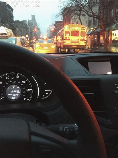 View of Traffic and Street Scene on Rainy Day through Car Windshield, New York City,