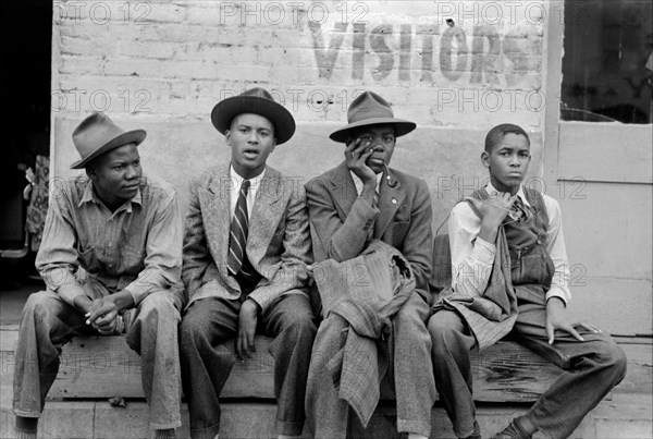 Four Young African American Men sitting on Bench, Waco