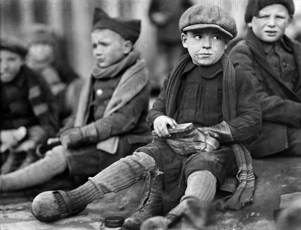 Young Orphan Boys shining their Leather Boots received from Junior Red Cross of America, Ypres