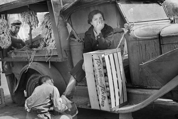 Wife of Fruit Vendor having Shoes shined at Market, San Antonio