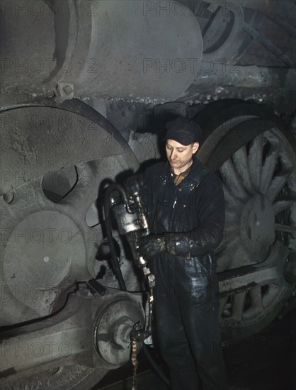 Worker greasing Locomotive in Roundhouse at Proviso Rail Yards, Melrose Park