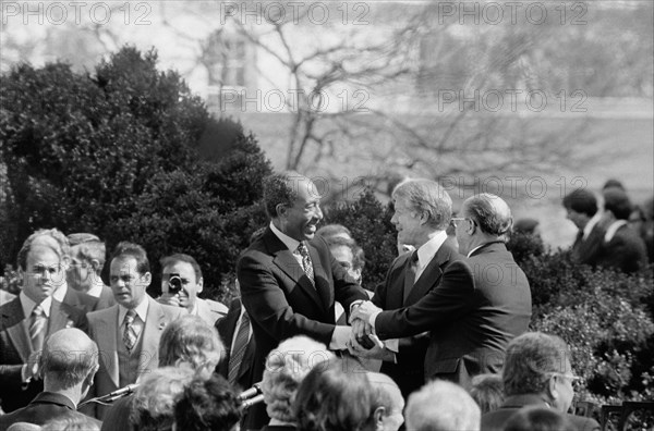 U.S. President Jimmy Carter shaking hands with Egyptian President Anwar Sadat and Israeli Prime Minister Menachem Begin at signing of Egyptian-Israeli Peace Treaty, White House