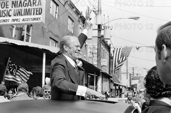 U.S. President Gerald Ford waves to crowd from the sunroof of a car in Philadelphia, Pennsylvania