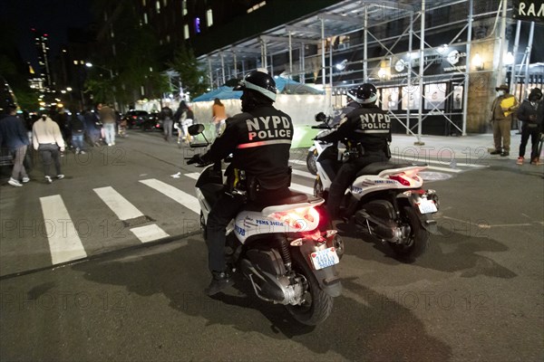Two NYPD Officers on Motorcycles, Street Scene at Night before Election