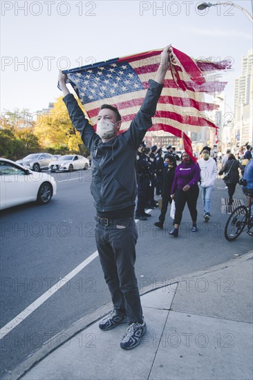 Man holding up American Flag during Celebration of President-Elect Joe Biden, Brooklyn