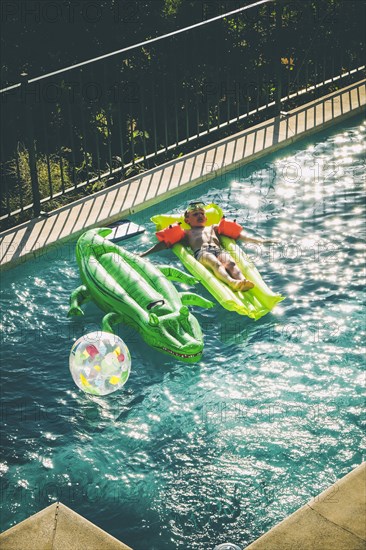 Young Boy on Float in Swimming Pool,