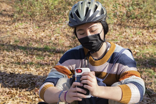 Teen Girl with Protective Mask Texting,