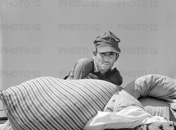 Head and Shoulders Portrait of Truck Owner who moved Family into new Prefabricated House