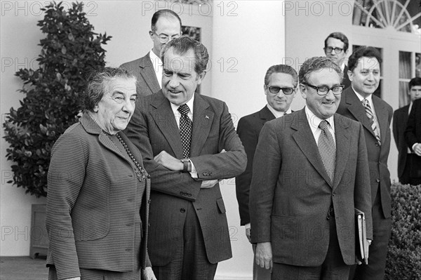Israeli Prime Minister Golda Meir standing with U.S. President Richard Nixon and U.S. Secretary of State Henry Kissinger