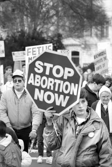 Young Person holding Sign that says "Stop Abortion Now" at Pro-Life March