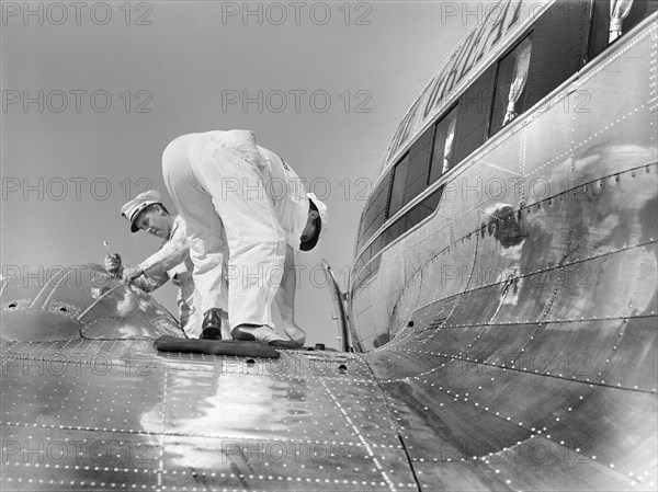 Mechanics checking fuel of Airliner