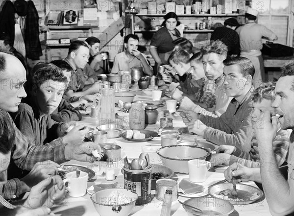 Pickers and Field Labors eating together in Converted Tool House during Lunch Hour