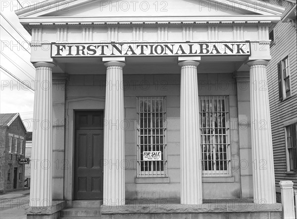 First National Bank with 'For Sale' Sign