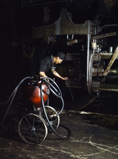 Thomas Madrigal greasing Locomotive Train in Roundhouse