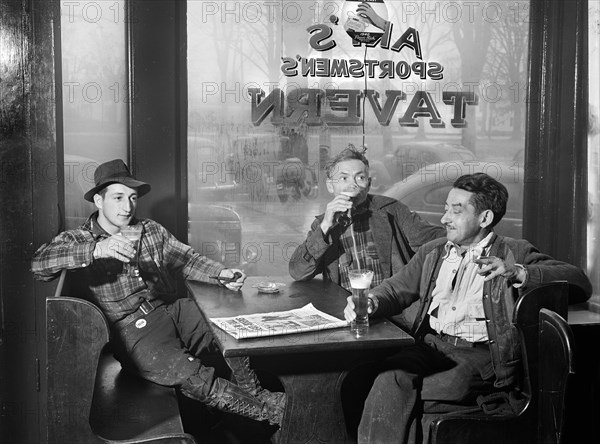 Three Men having Beer in Art's Sportsmen's Tavern on rainy day
