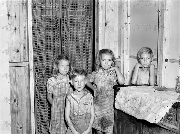 Children of Family that moved into Prefabricated House built by U.S. Farm Security Administration (FSA) to house some of Farmers who had to move out of the area being taken over by the Army