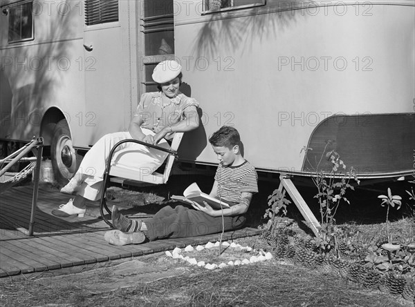 Mother listening to son read. Sarasota trailer park