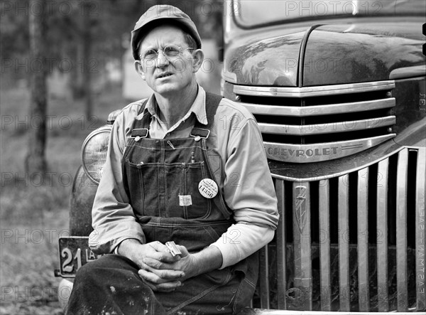 Construction Worker sitting on Car before leaving for Evening Shift