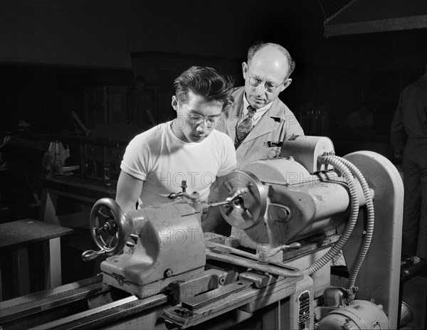 Chinese-American Student learning to operate Lathe to help in War Program