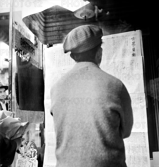 Chinese Man reading News of the Surrender of Canton to the Japanese