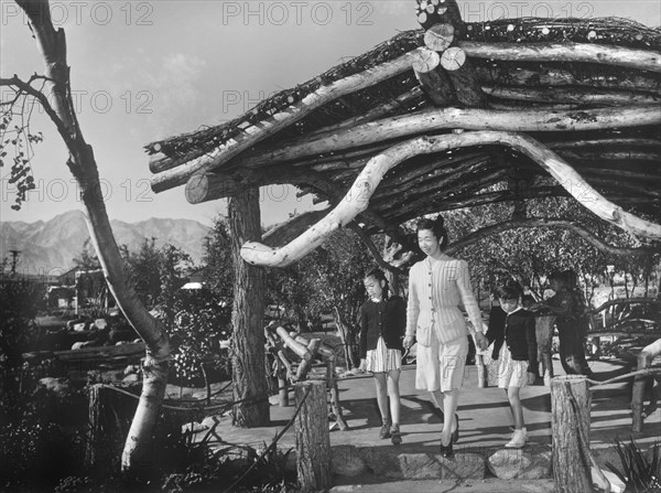 Yaeko Nakamura holding hands with her two Daughters