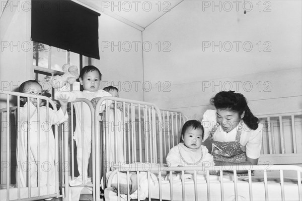 Nurse tending to Orphan Infants in Nursery