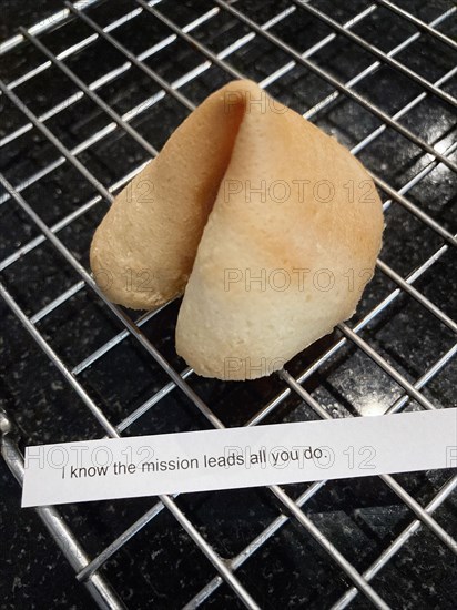 Homemade Fortune Cookie with Fortune Message on Cooling Rack