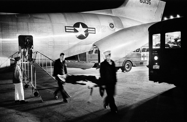 Military Staff carrying wounded Serviceman