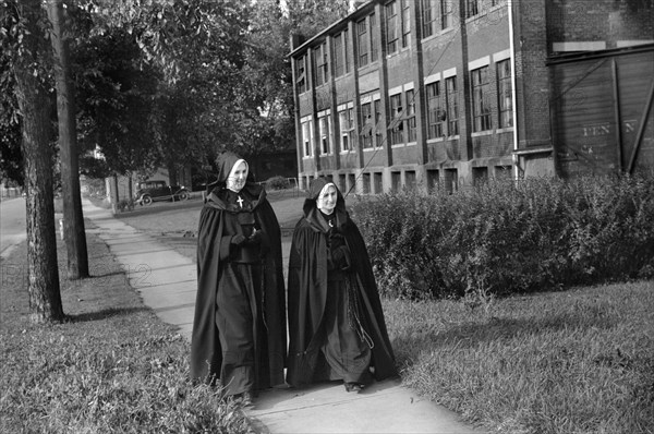 Two Nuns walking along Street