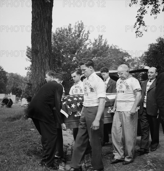 Pallbearers with flag-covered casket