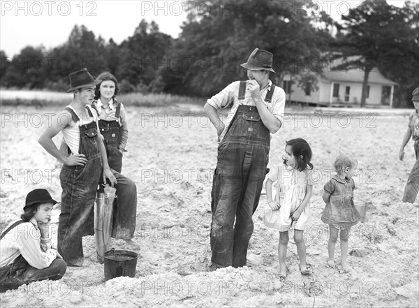 Tenant Farmer with his Children in Field ready for Tobacco Planting