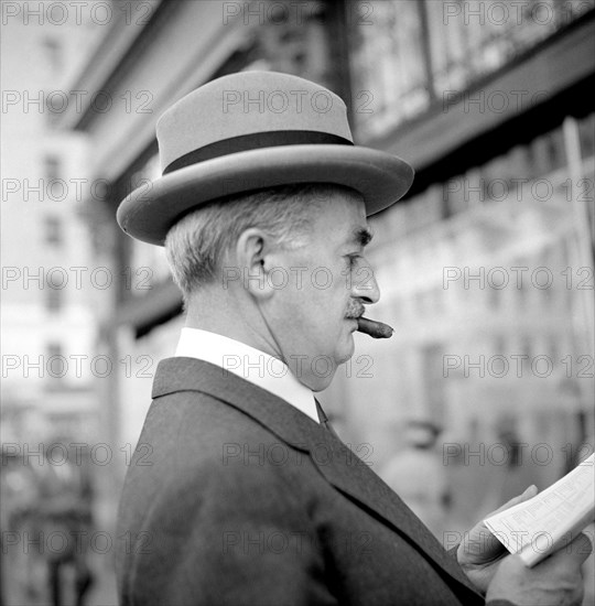 Head and Shoulders Profile of Man reading Newspaper