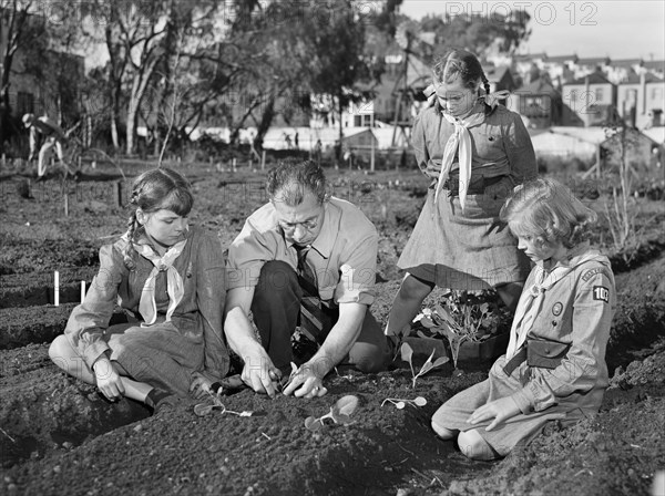 Harry Nelson helping his Girl Scout daughter Pat Nelson