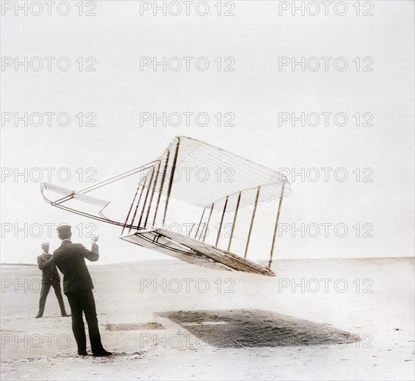 Side view of glider flying as kite near ground