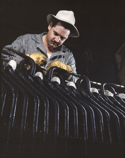 Man working with generator stator at hydroelectric plant at Wilson Dam