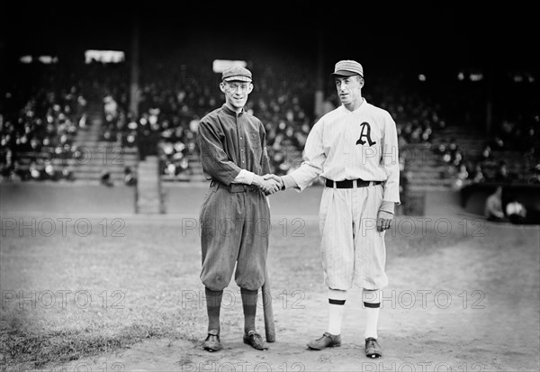 Johnny Evers (left) of National League champion