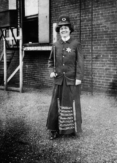 Suffragist posing in Police Uniform to illustrate Woman Police Concept