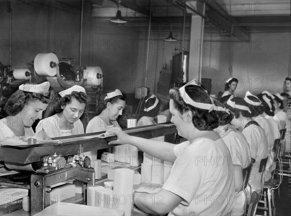 Female Workers wrapping butter by hand