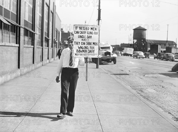 Man with Protest Sign outside Bowman Dairy