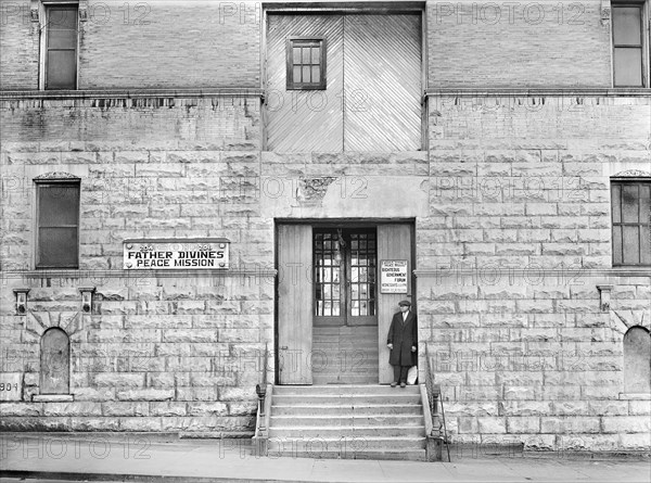 Man standing on steps of Father Divine's Peace Mission