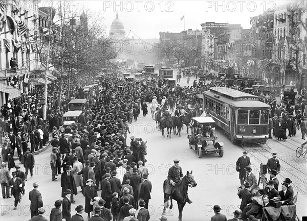 Crowd watching Suffragettes marching in Parade