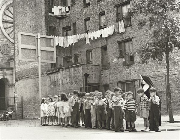 Nun with group of young schoolchildren in Playground